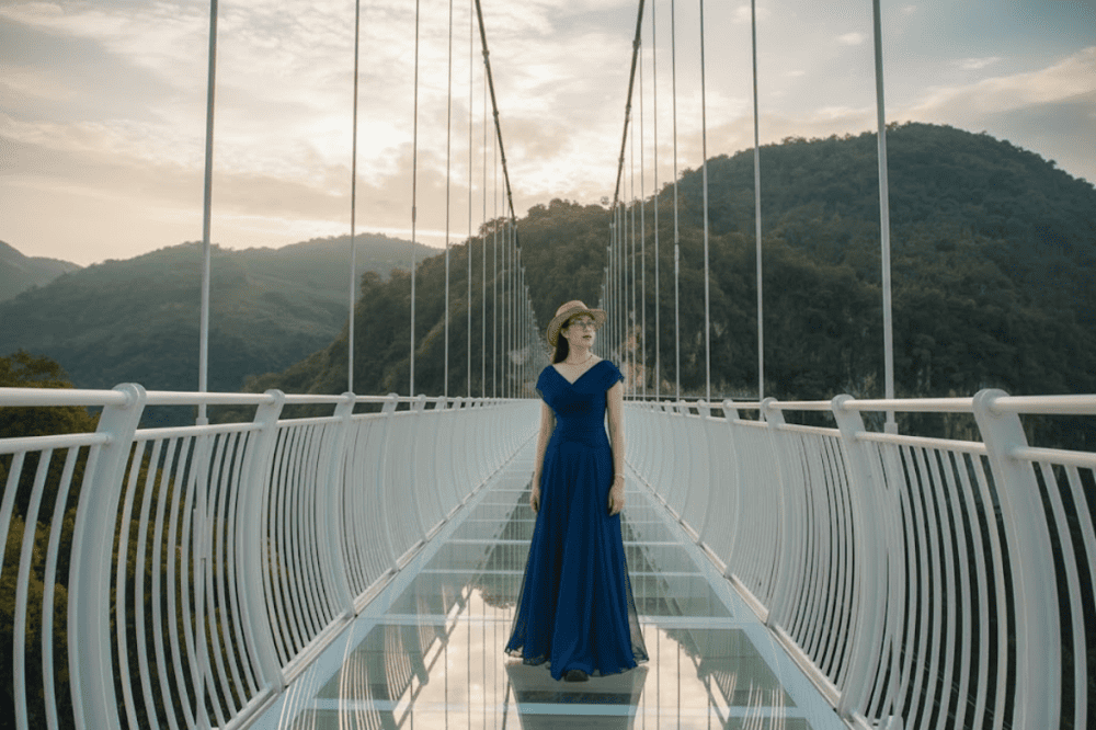 Du khách trải nghiệm đi bộ trên mặt kính trong suốt trong thời tiết trong xanh mát mẻ